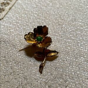 Elegant Gold Flower Brooch with Green Accent